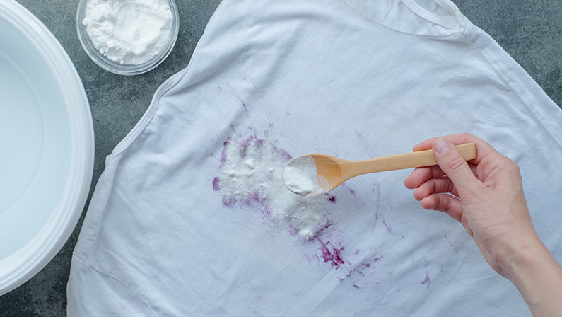 Homemade eco-friendly removing of stains on clothes with baking soda.