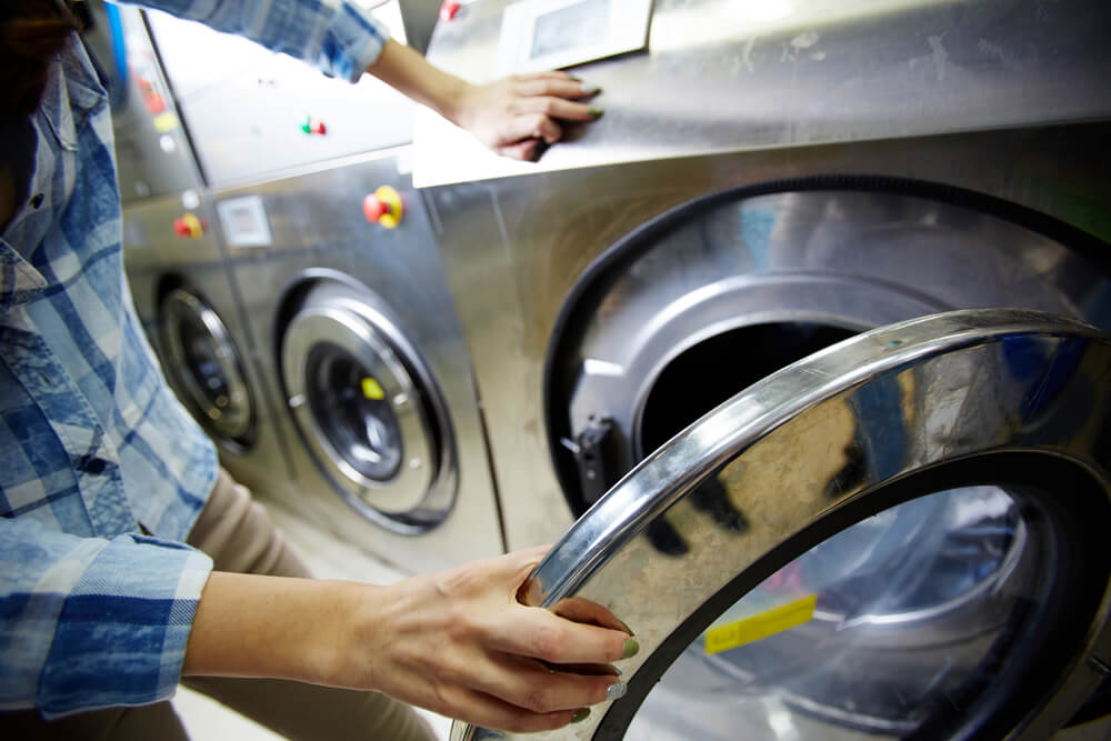 Opening tumble in washteria to wash laundry