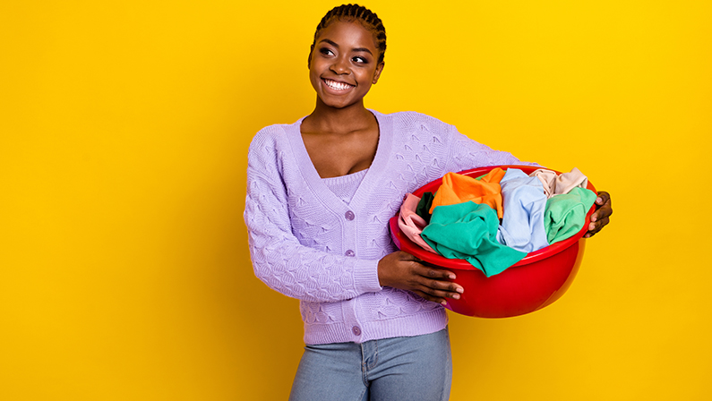 Cheerful pretty person hands hold laundry basket